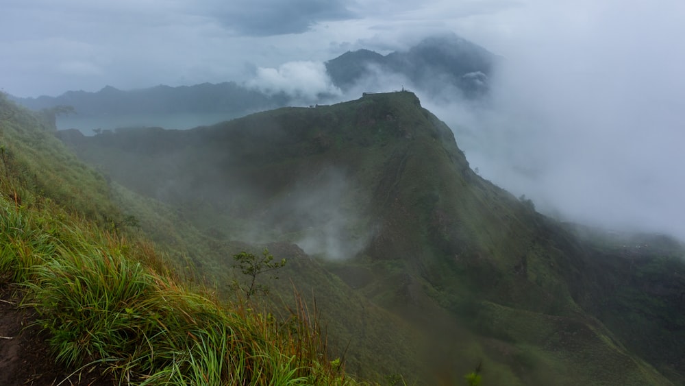 a view of a mountain with a few clouds in the sky