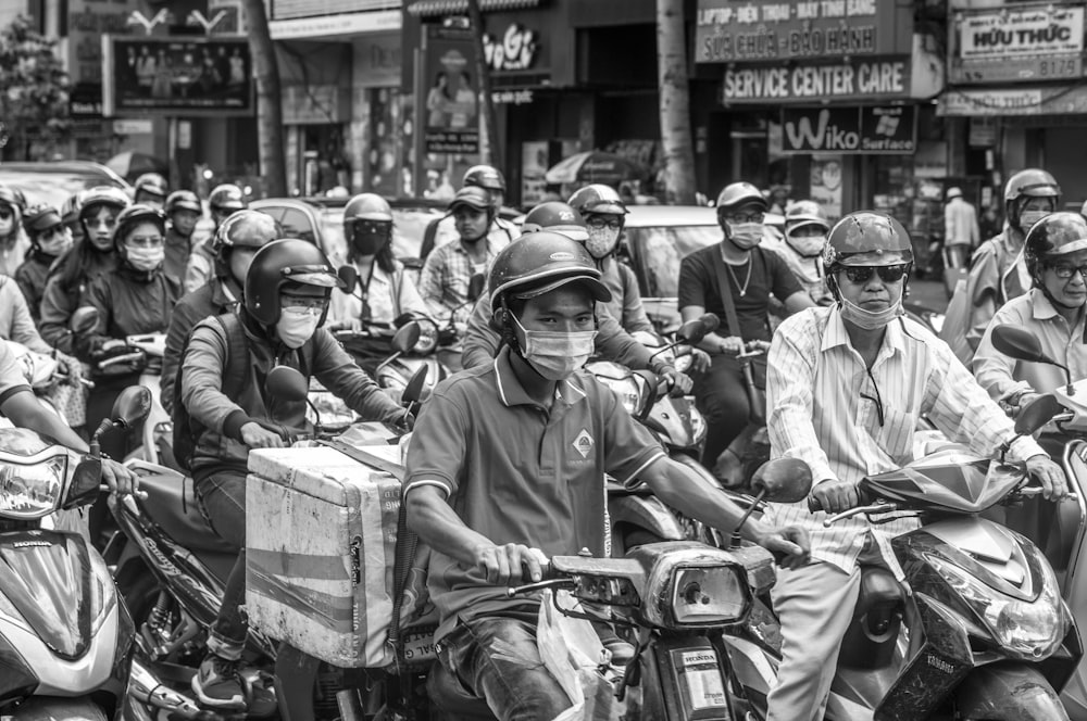 a group of people riding motorcycles down a street