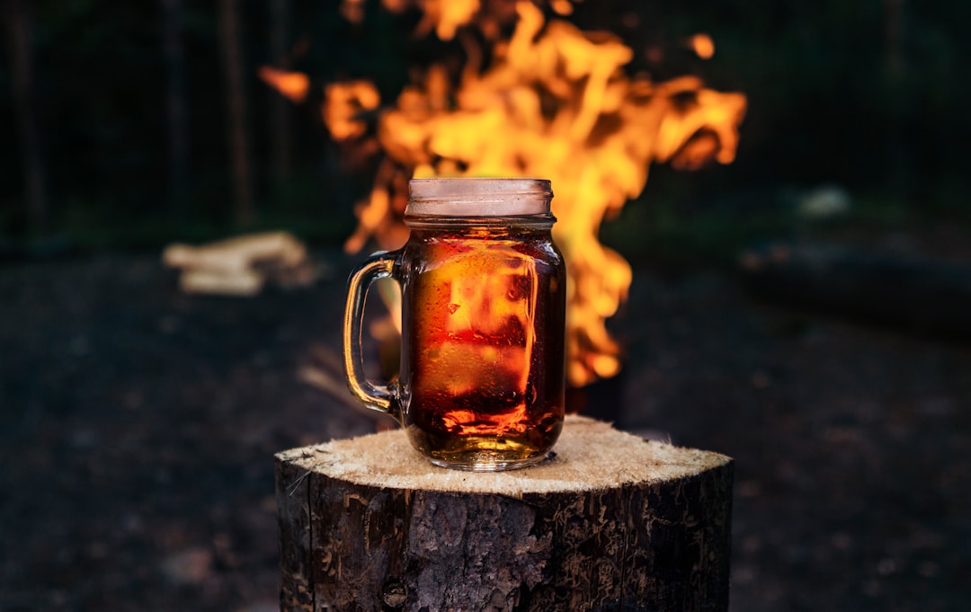 clear glass mug with brown liquid inside