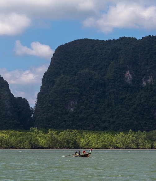 a man in a small boat on a large body of water