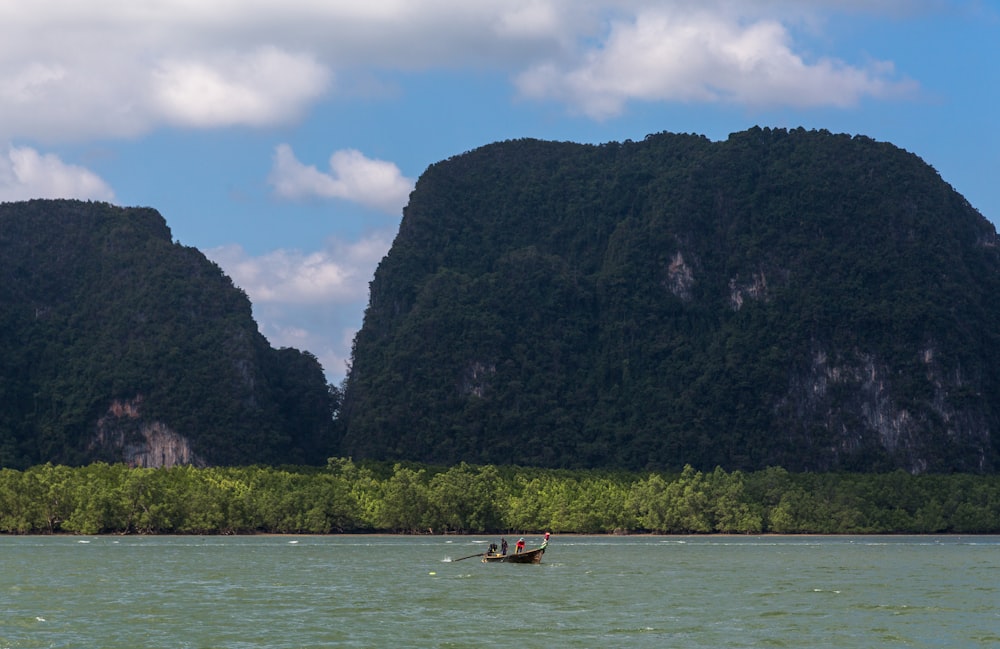 a man in a small boat on a large body of water