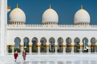 people walking near white concrete building during daytime