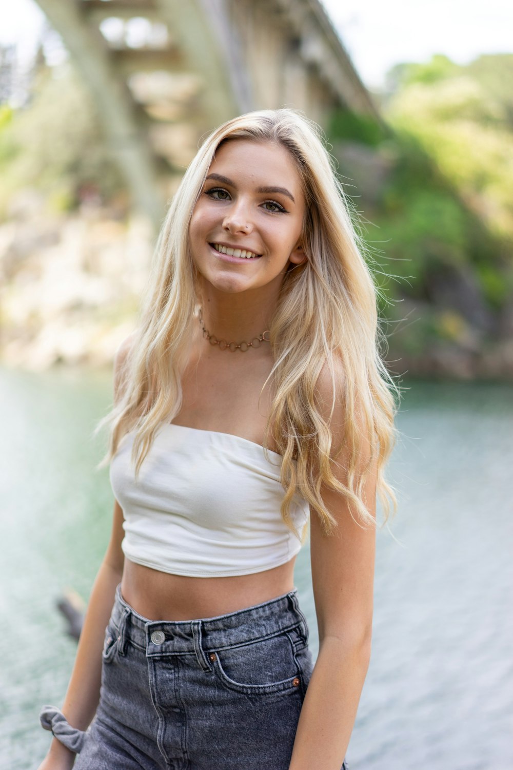 woman in white off shoulder shirt and black denim shorts smiling