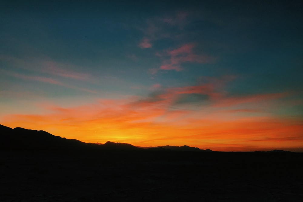 silhouette of mountain during sunset