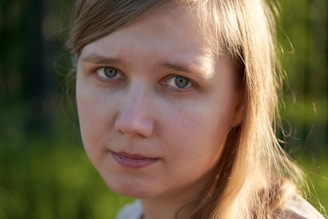 A candid portrait of Gintare Juknaite in natural light, showcasing her blonde hair and blue eyes.