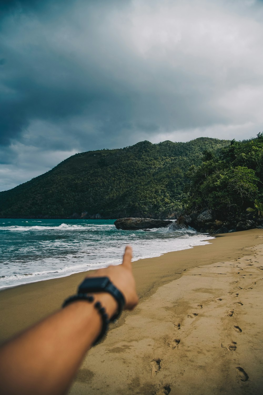 person in black watch on beach during daytime