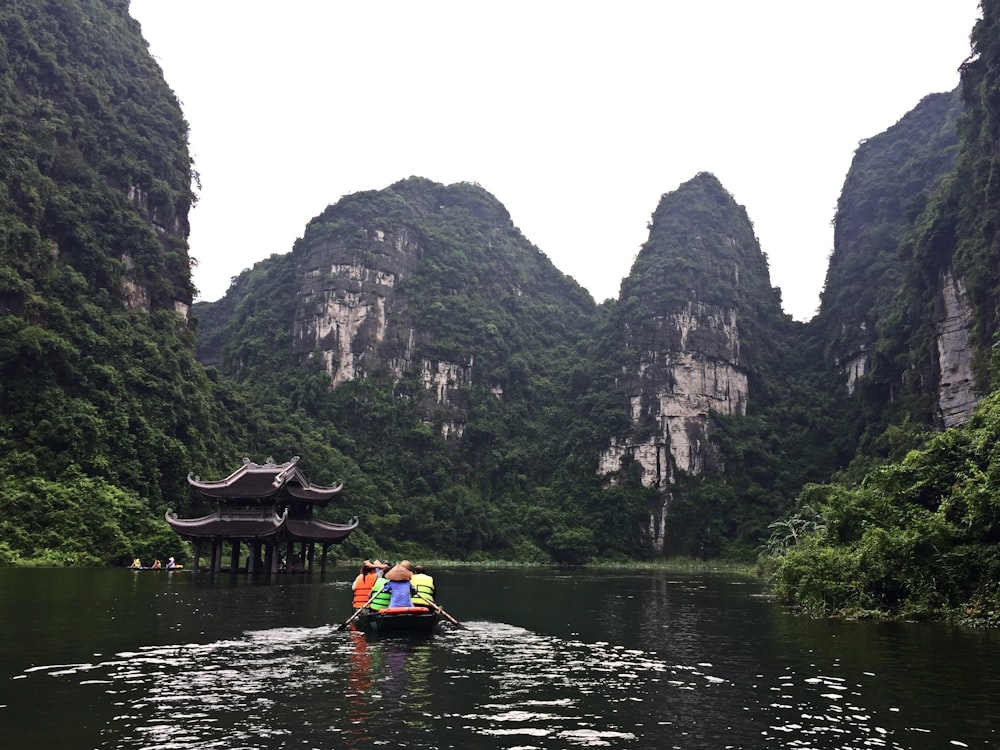 people riding on boat on river during daytime