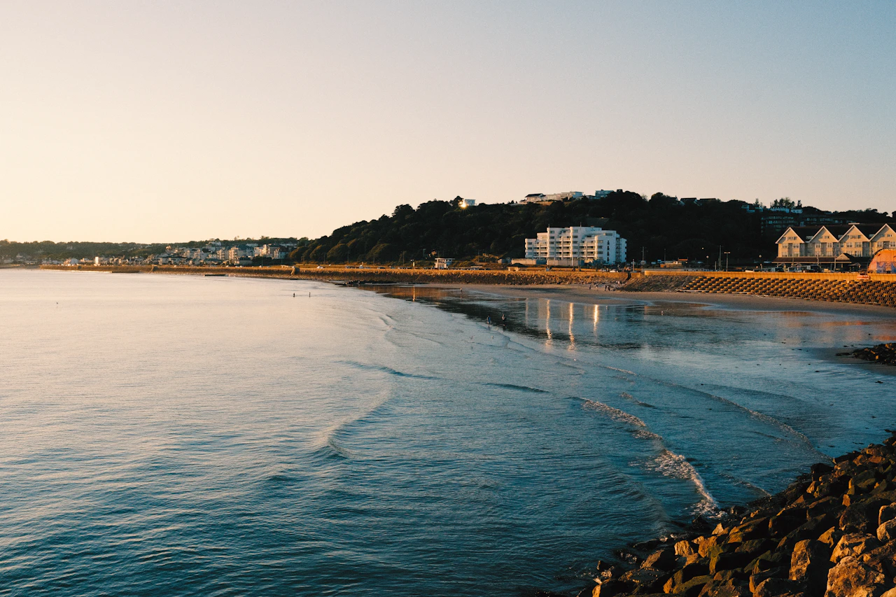 A white and blue building beside the water in Jersey, Channel Islands