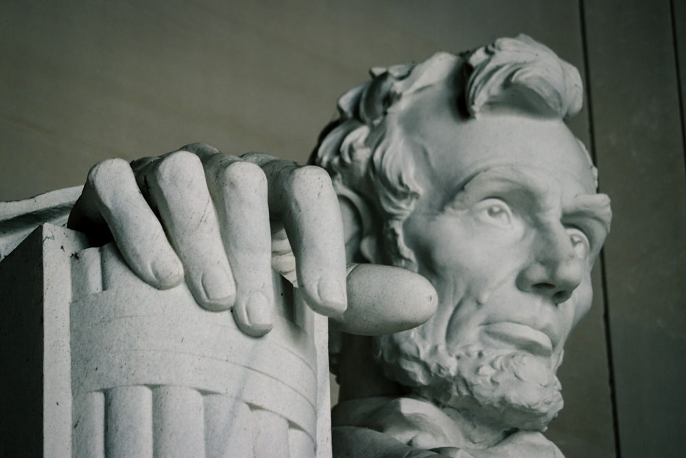 gray scale photo of man holding his face