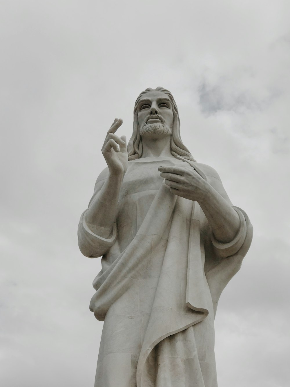 a statue of jesus holding his hand up