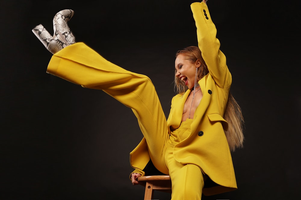 woman in yellow robe holding yellow textile