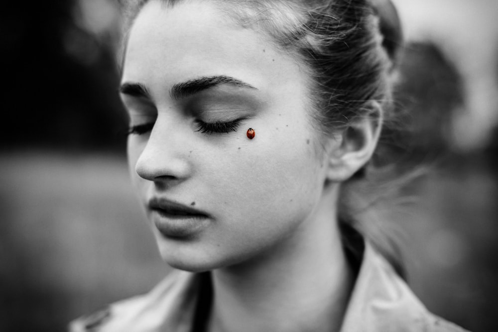 a woman with a red dot on her forehead