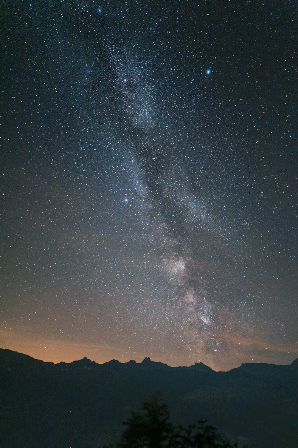 silhouette of mountain under starry night