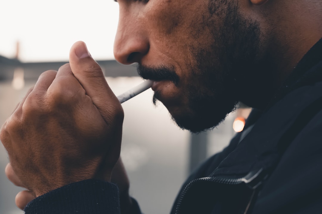 man smoking cigarette during daytime
