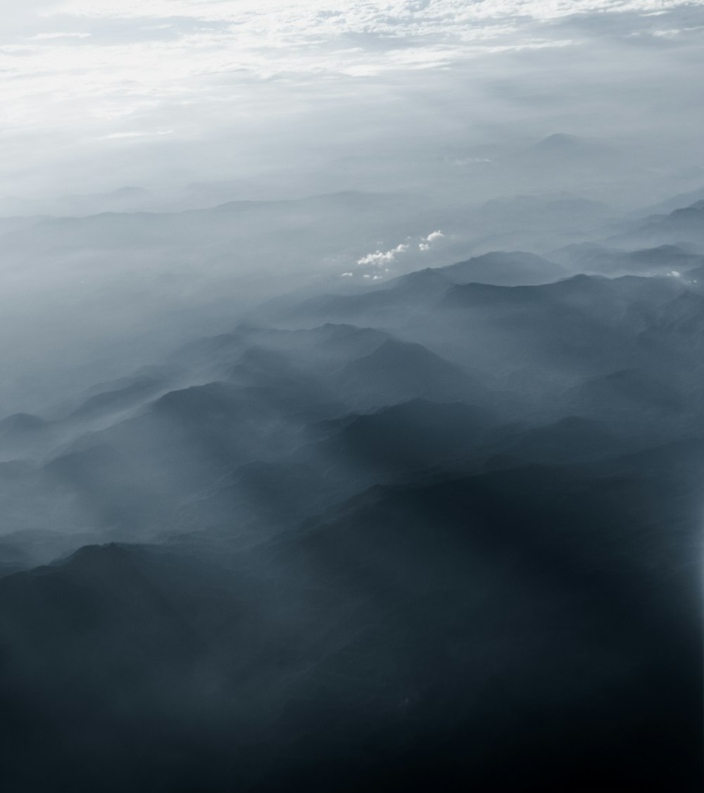 white clouds over mountains during daytime