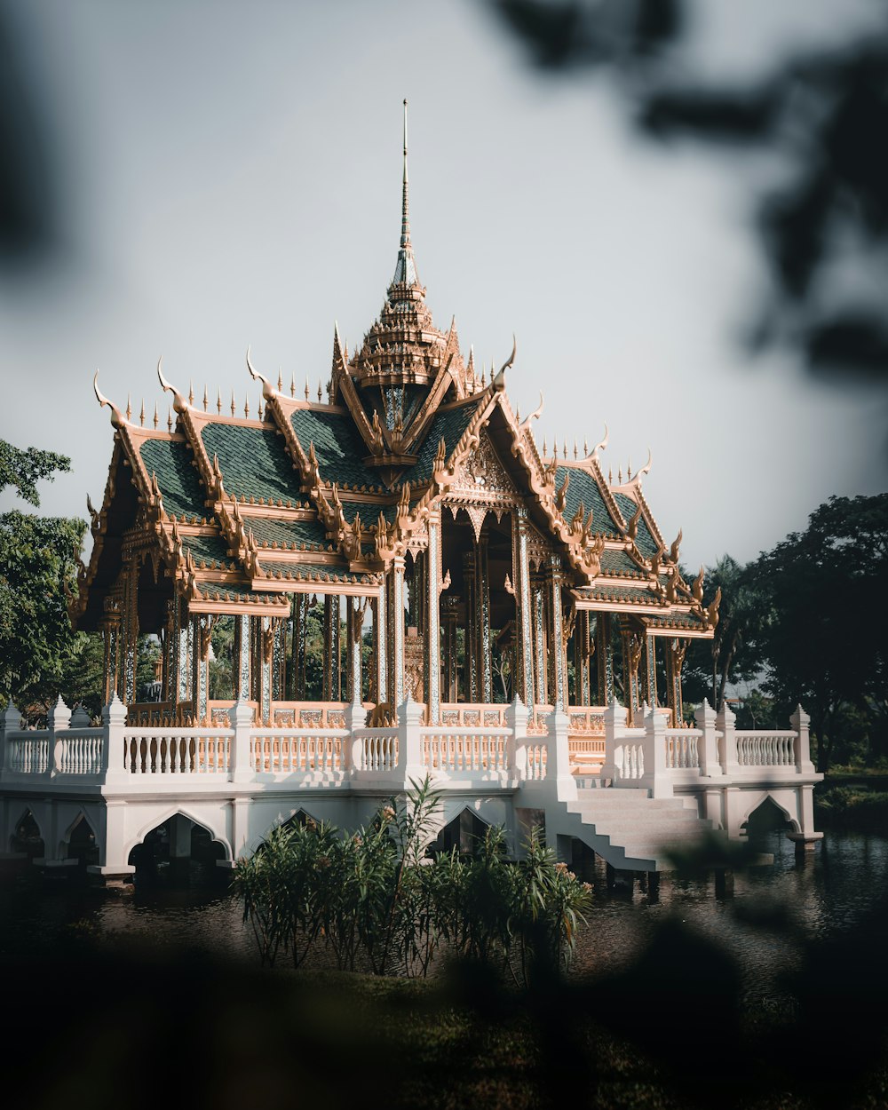 white and brown temple near body of water