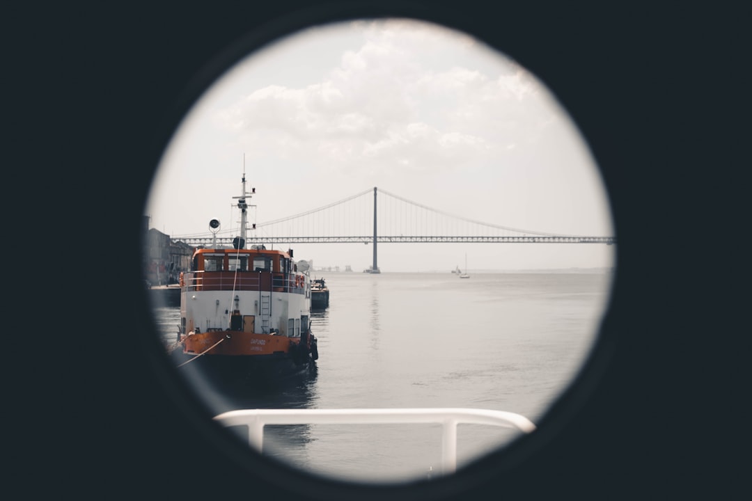 red and white ship on sea under white sky during daytime