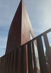 A sturdy metal building framed against a bright Texas afternoon.