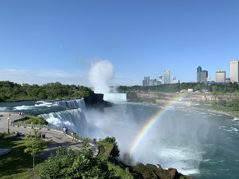 water falls under blue sky during daytime