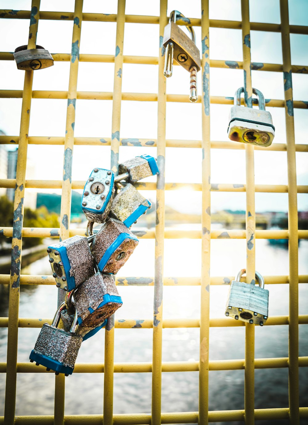 blue and brown padlock on blue metal fence