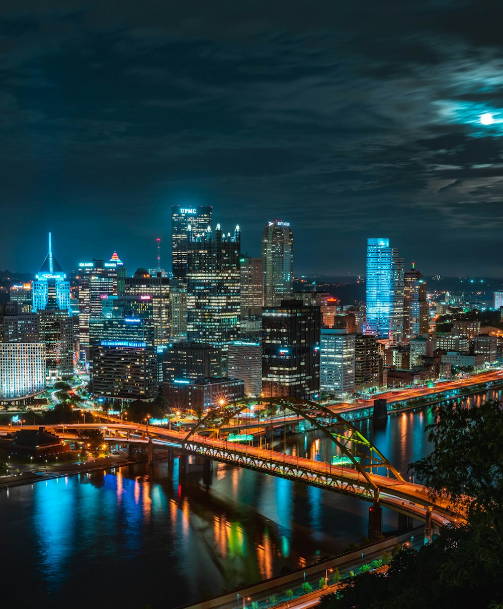 a city at night with a bridge and lights