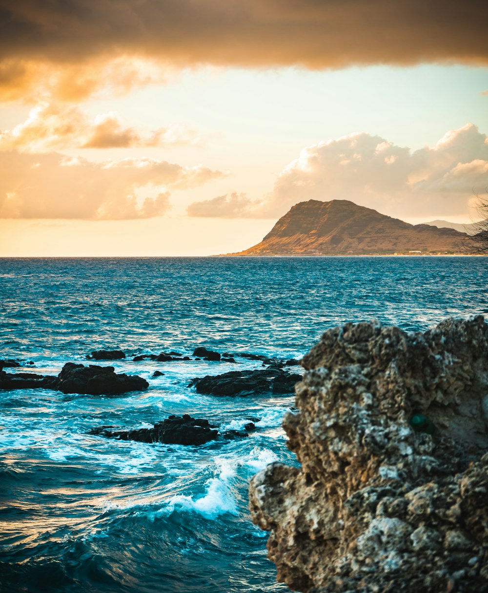 brown rock formation on sea during daytime