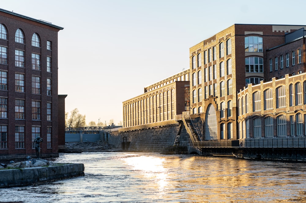 brown concrete building near river during daytime