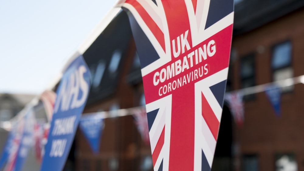 a british flag hanging from the side of a building