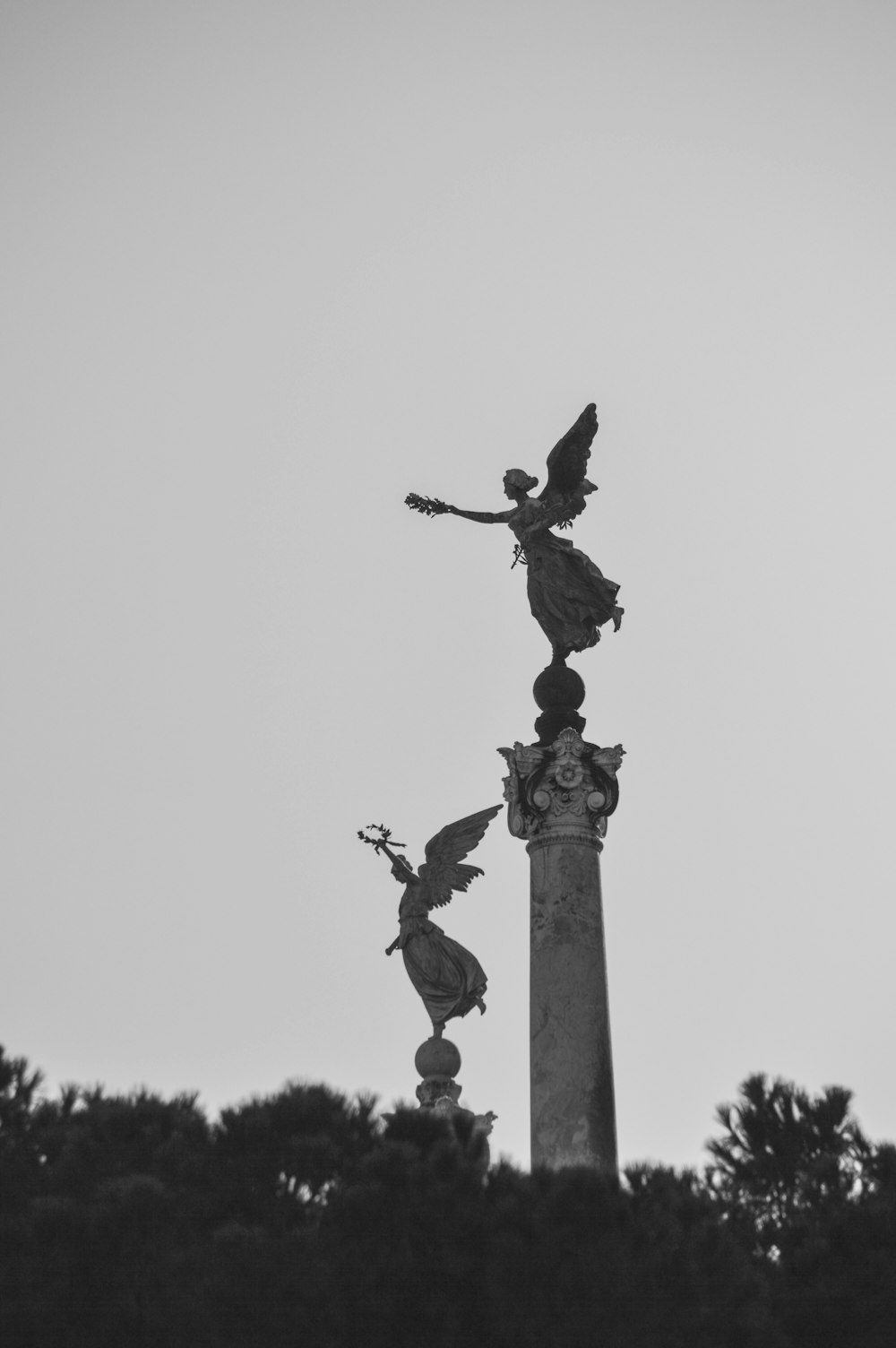 black statue of man raising his right hand