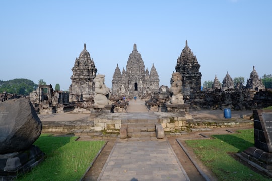 gray concrete building under blue sky during daytime in Prambanan Temple Indonesia