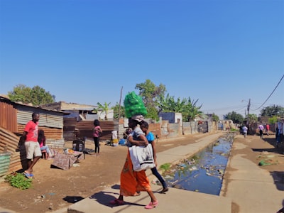 woman in white shirt and orange skirt walking on gray concrete pathway during daytime mozambique google meet background