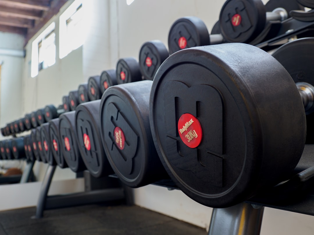black and red dumbbell on rack
