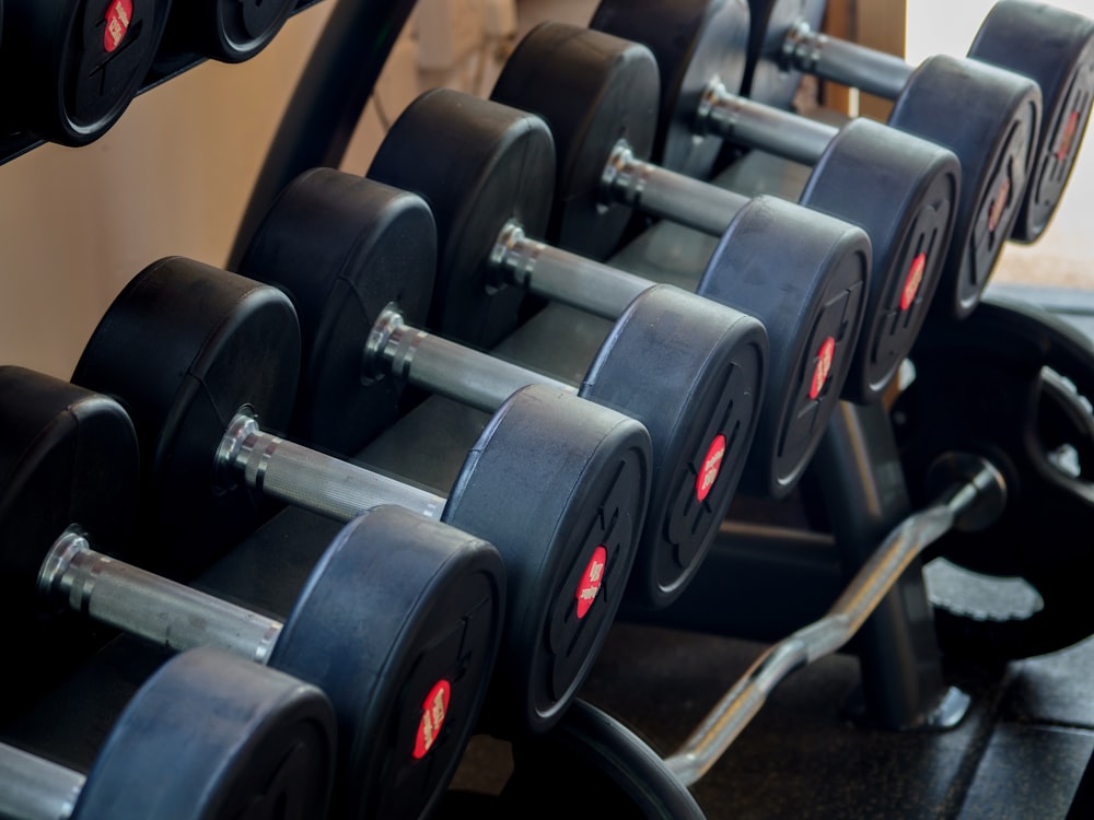 black and gray dumbbells on rack