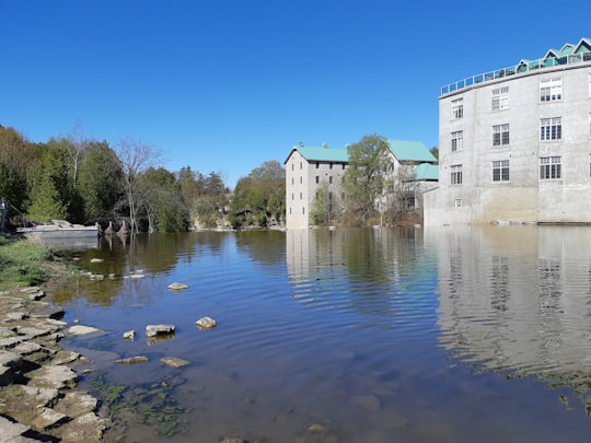 white concrete building near body of water during daytime in Fergus Canada