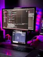 Dark-themed workspace with multiple screens displaying automation code and design sketches.