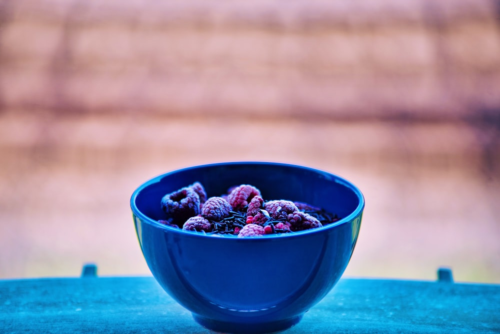 blue ceramic bowl with red and black berries