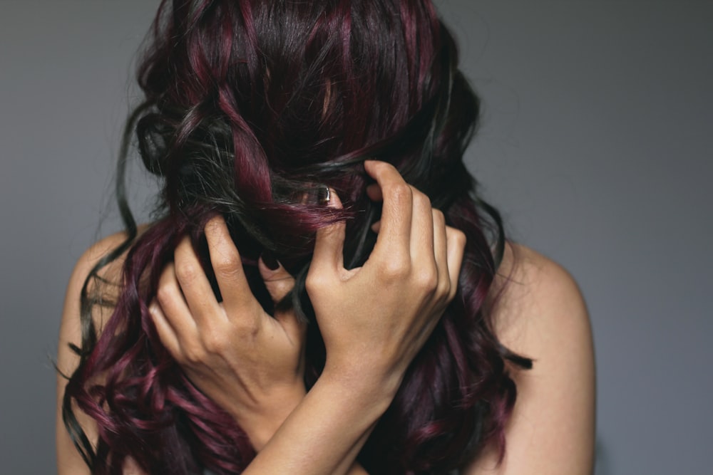 woman covering her face with her hair