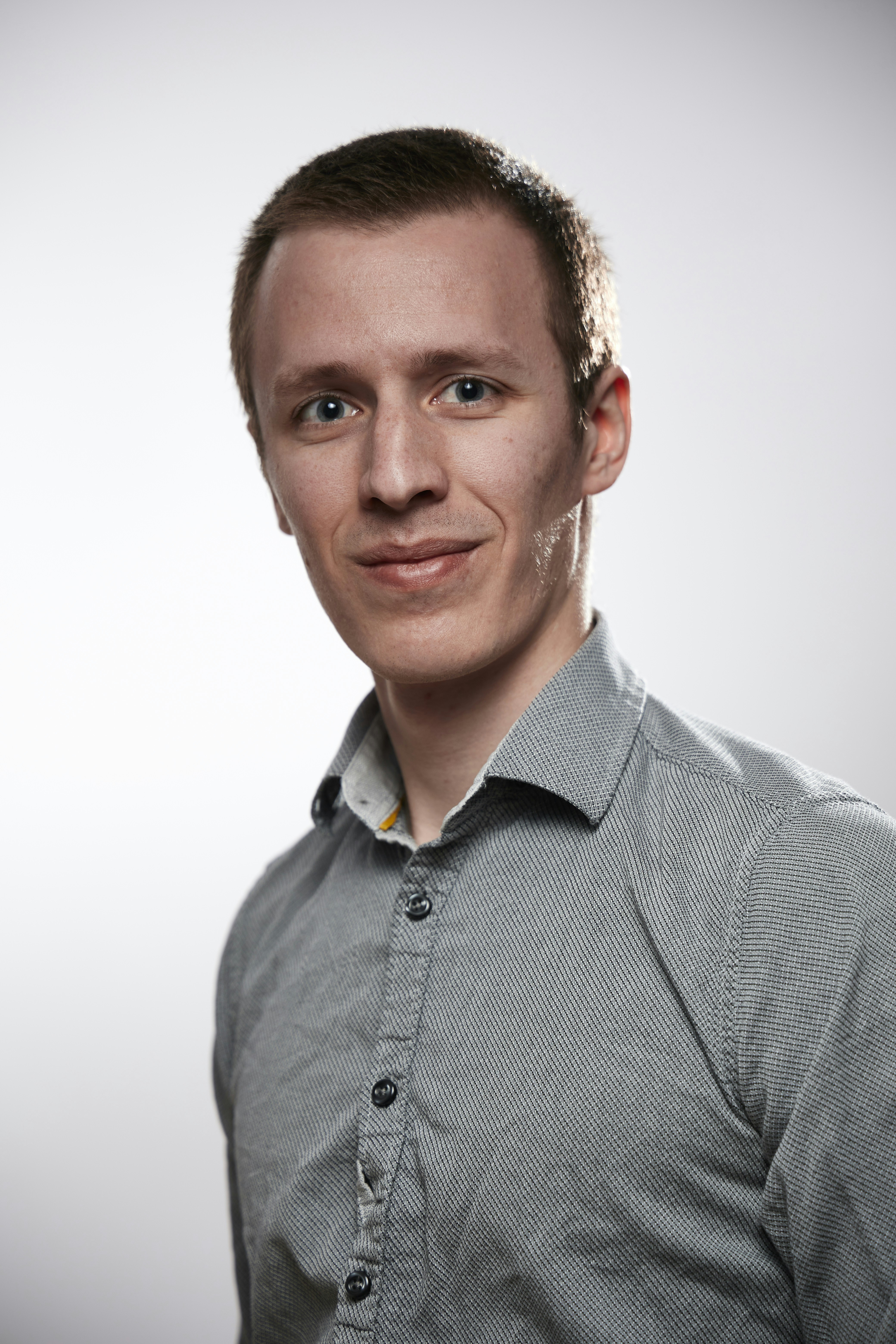 Portrait of a smiling man in clean cloths on a white background. Self portrait taken to test a brand new EOS RP.