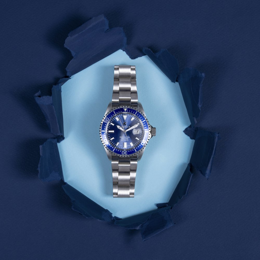blue and silver round analog watch