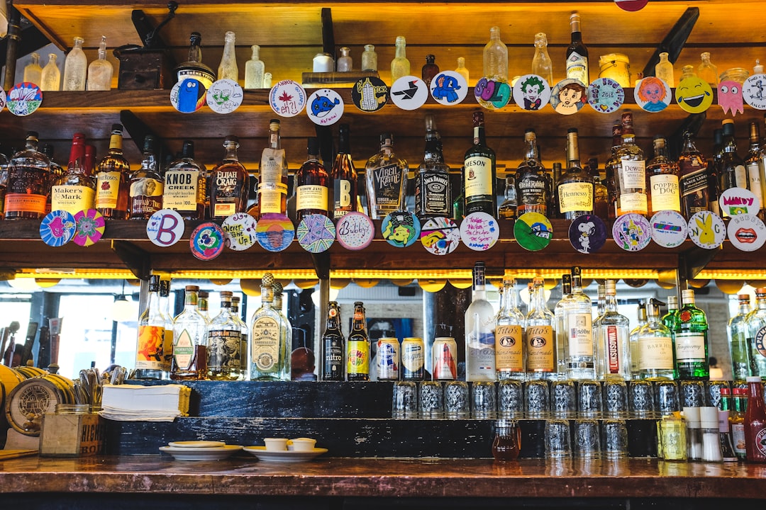 assorted bottles on brown wooden shelf