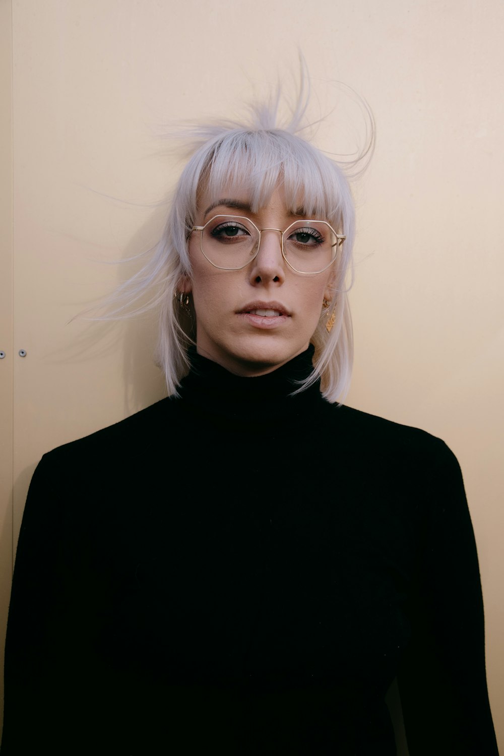 woman in black turtleneck sweater wearing eyeglasses