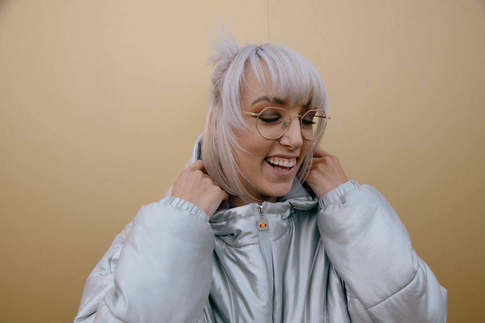 woman in gray zip up jacket smiling