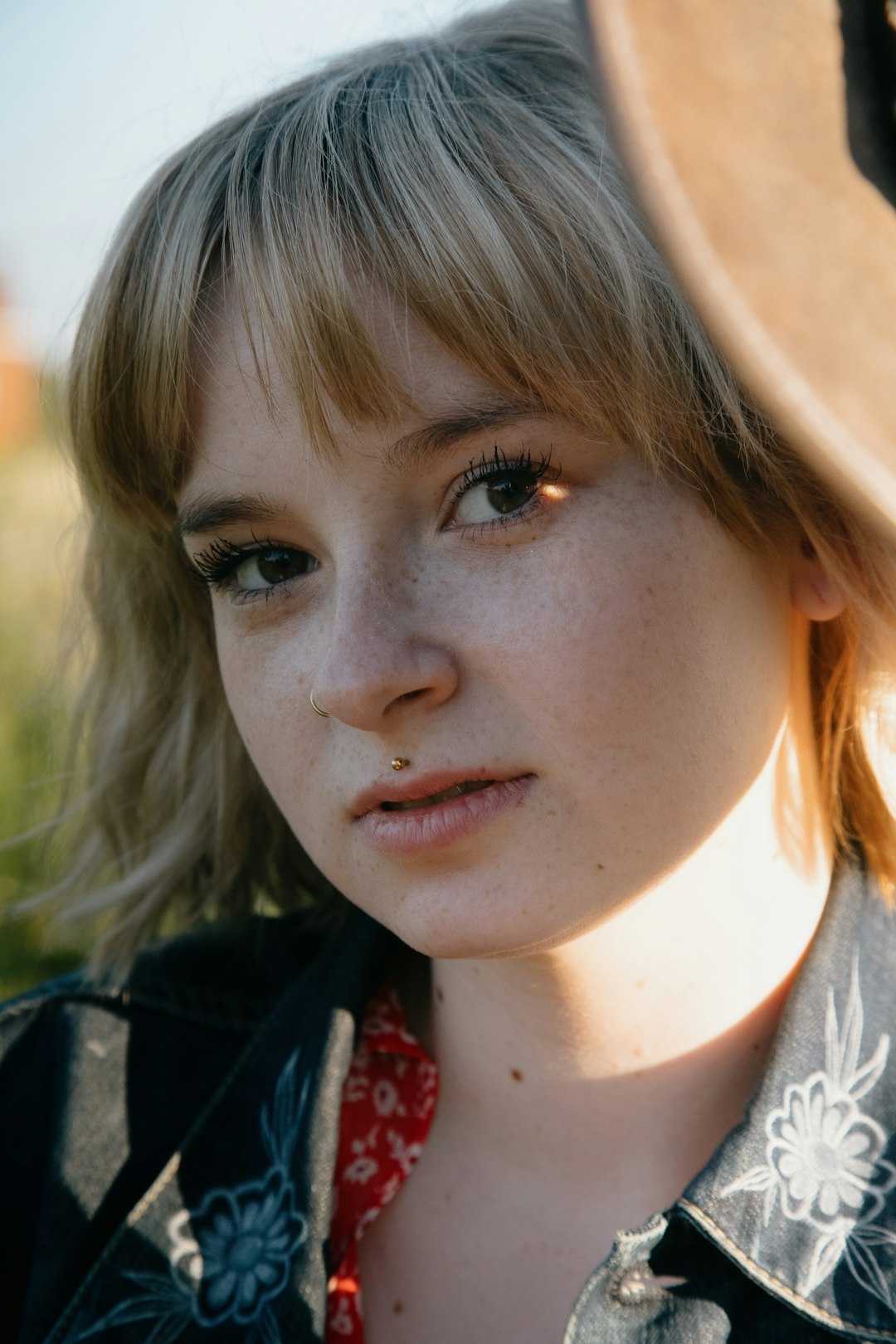 girl in black jacket and red and white floral shirt