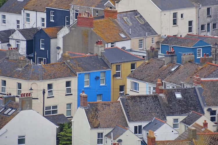 Rows of terrace houses, some of which are painted bright blue and yellow