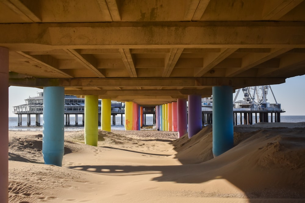 brown wooden posts on brown sand during daytime