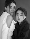 two women are posing for a black and white photo