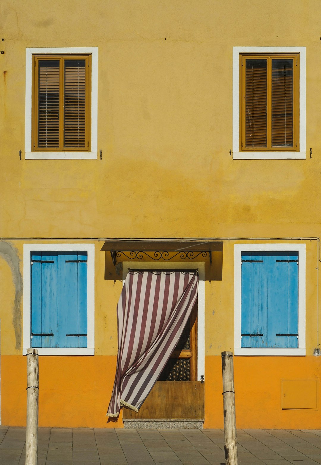 blue wooden door on yellow concrete building