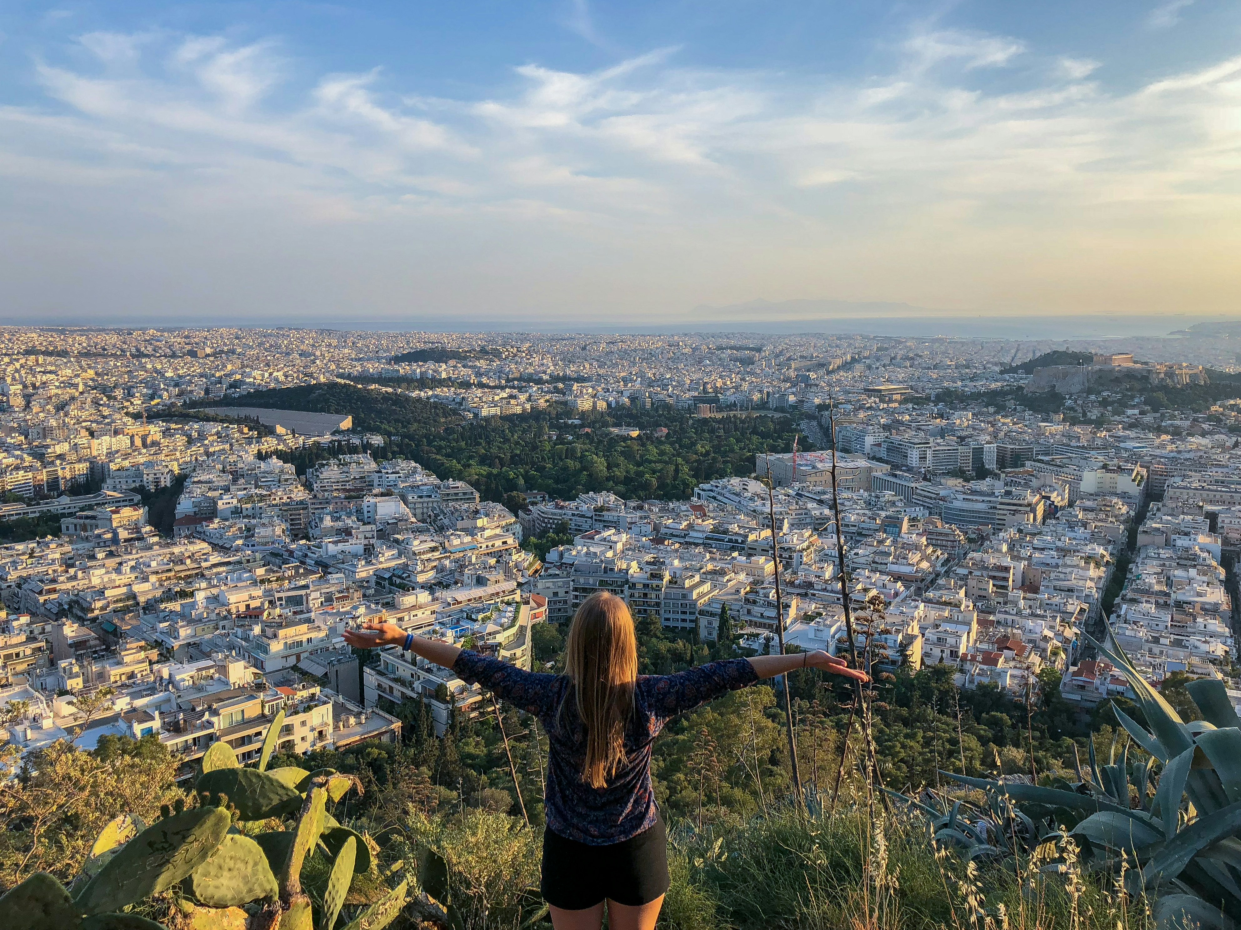 woman in black long sleeve shirt standing on top of the mountain during daytime