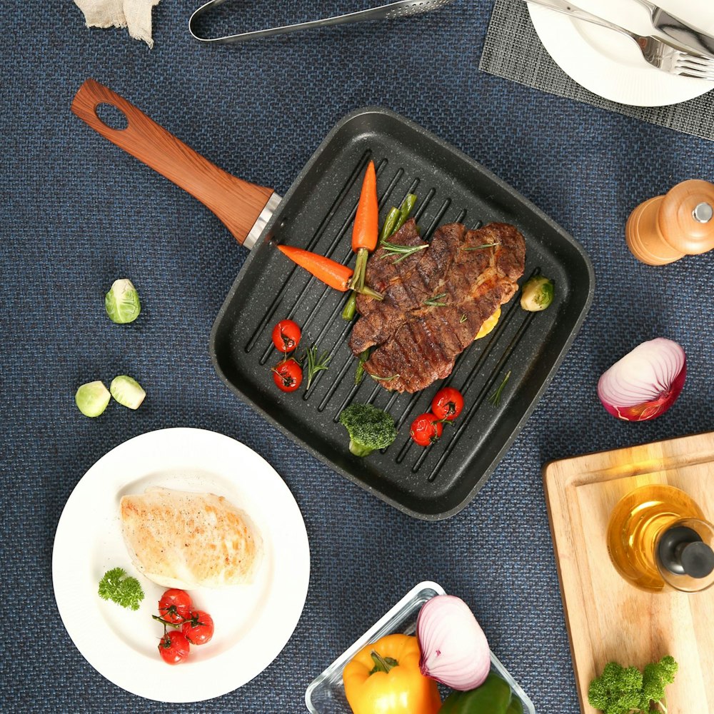 cooked meat with sauce on black rectangular tray