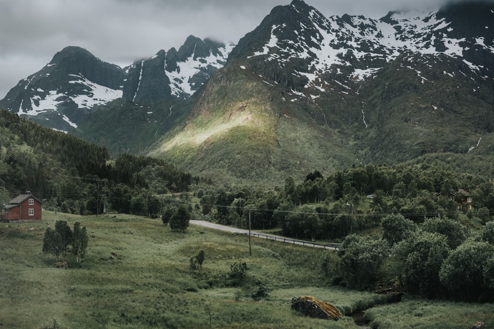 green grass field near mountain during daytime